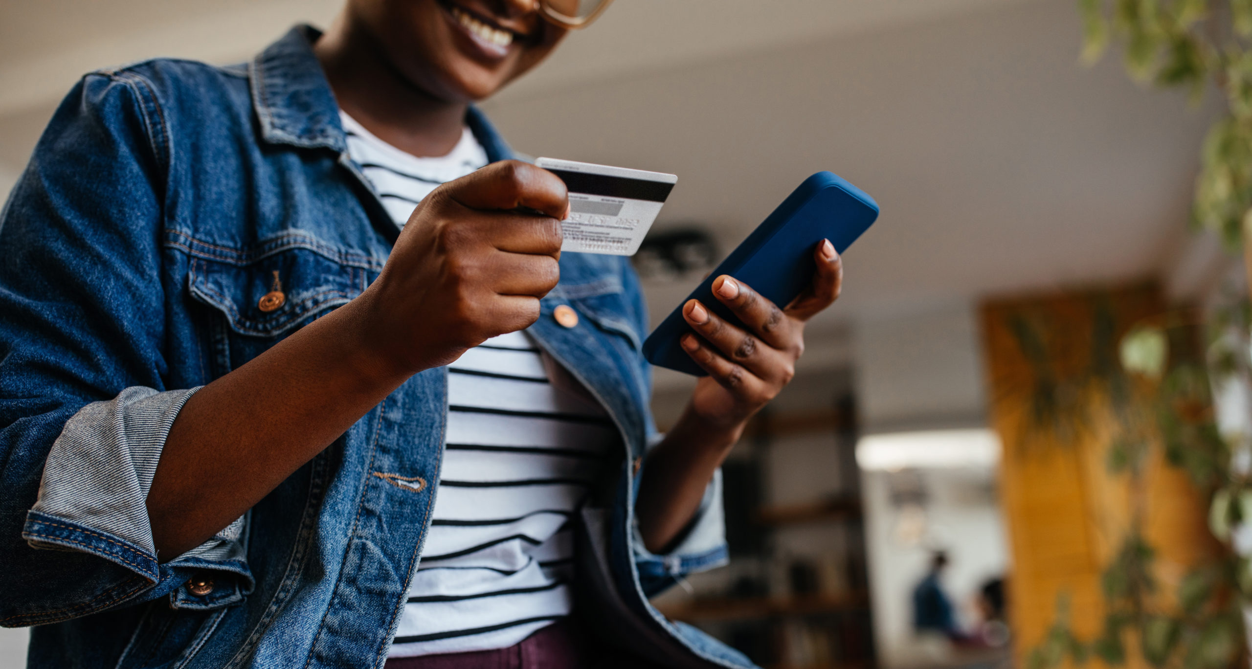 lady with card and phone